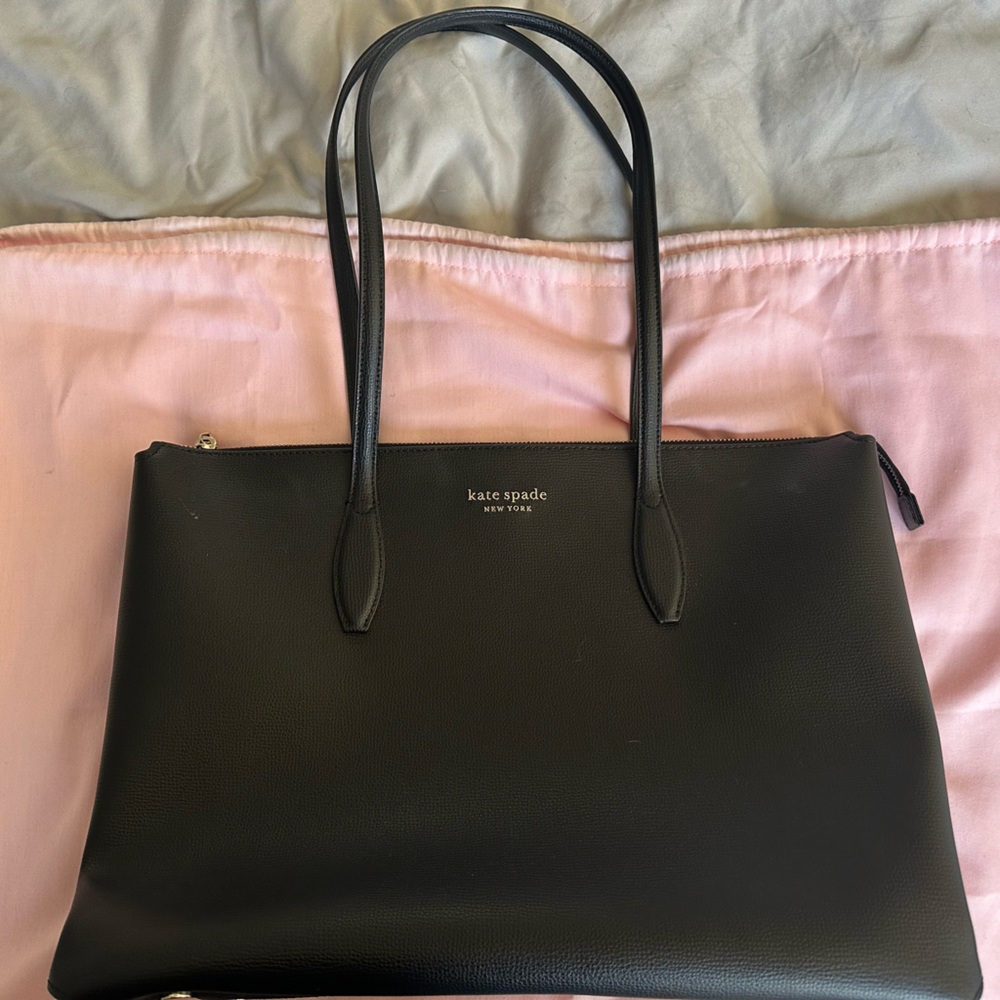 Kate Spade laptop purse. Used with some marks on the exterior.